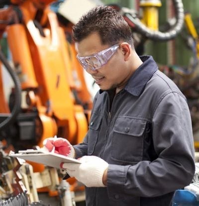 IEC 61508 - Functional Safety of Electrical/ Electronic/ Programmable Electronic Safety-related Systems - Man in a factory with clipboard